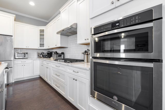 a white kitchen with modern appliances